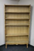 A set of blond oak open bookshelves