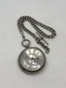 A large antique silver pocket watch with silver dial on heavy antique silver Albert chain