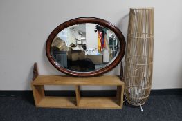 A pine wall shelf, oval shaped mirror,
