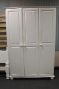 A painted pine triple door wardrobe