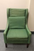 A mid 20th century Danish wingback armchair in green fabric