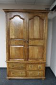 A contemporary hardwood double door wardrobe fitted four drawers