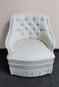 An Art Deco style bedroom chair in cream fabric