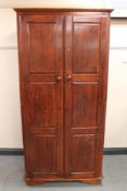 A stained pine double door wardrobe
