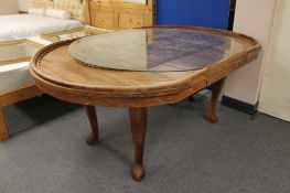 An Indian hardwood extending dining table with carved panel