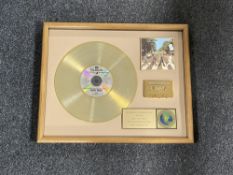 A framed The Beatles Abbey Road limited edition gold record,