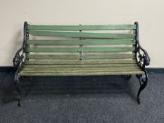 A cast iron and wooden slatted garden bench