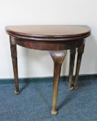 A Victorian D-shaped turnover top table on club feet