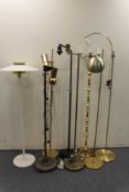 Eight assorted continental metal floor lamps