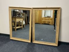 A pair of oak framed wall mirrors