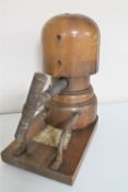 An antique wooden hat stretcher