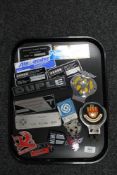 A tray of 20th century card badges and coach work plaques,