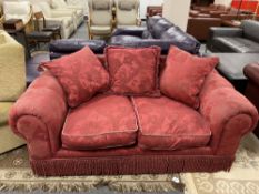 A two seater Victorian style settee in red brocade