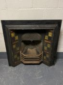 An antique cast iron tiled fire place