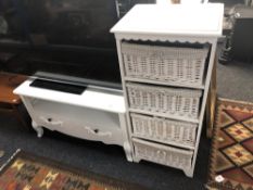 A painted white four drawer chest with wicker drawers and a TV stand