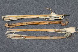 Three vintage split cane fly rods in carry bags and a two piece fly rod
