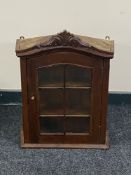 A hardwood single door wall cabinet