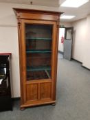 A continental walnut glazed bookcase, width 82 cm.