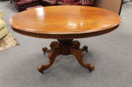 A Victorian mahogany oval tilt topped breakfast table on four way pedestal