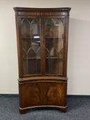 A reproduction mahogany concave corner display cabinet (locked,