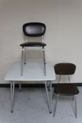A mid 20th century folding kitchen table on tubular metal legs and two chairs