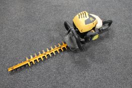 A JCB petrol hedge trimmer