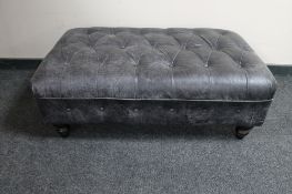 A black leather oversized footstool