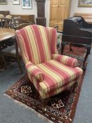 A contemporary armchair on claw and ball feet,