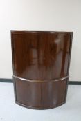 A mid 20th century walnut double door corner cabinet