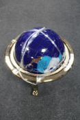 A large gemstone globe on stand
