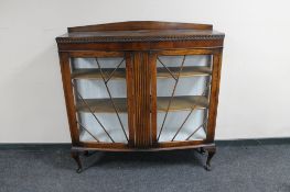 An Edwardian carved oak double door display cabinet