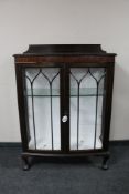 An Edwardian mahogany double door display cabinet on claw and ball feet