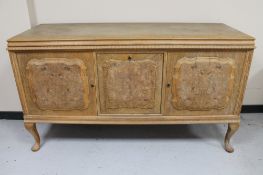 An early 20th century blonde oak triple door sideboard CONDITION REPORT: width 169
