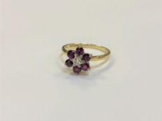 An 18ct gold ruby and diamond cluster ring, size O/P, 3.2g.
