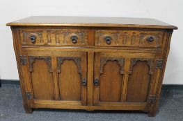 A carved oak double door sideboard