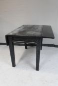 An antique painted pine flap sided table