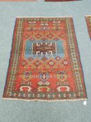 A Caucasian rug on red ground,