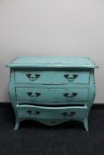 A contemporary painted three drawer bombe commode chest