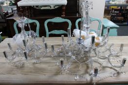 A contemporary glass twelve branch chandelier with glass drops together with a matching nine branch