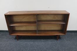 A set of mid century teak sliding glass door bookshelves
