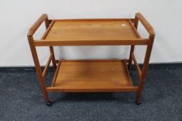 A mid century teak two tier tea trolley