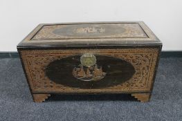 A carved camphor wood blanket box