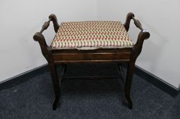 An Edwardian storage piano stool