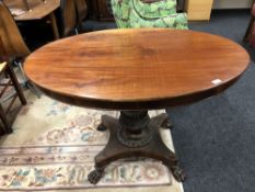 A 19th century continental mahogany pedestal table on paw feet