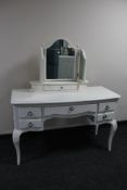 A contemporary white French style kneehole dressing table with triple mirror
