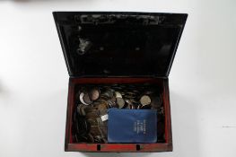 An antique metal cash box with key containing a large quantity of British pre decimal coins,