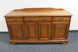 A Ducal pine four door sideboard