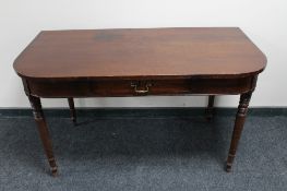 A Victorian mahogany D-end table fitted with a drawer