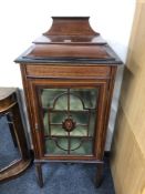An Edwardian inlaid mahogany display cabinet