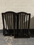 Two wooden three way folding dog gates